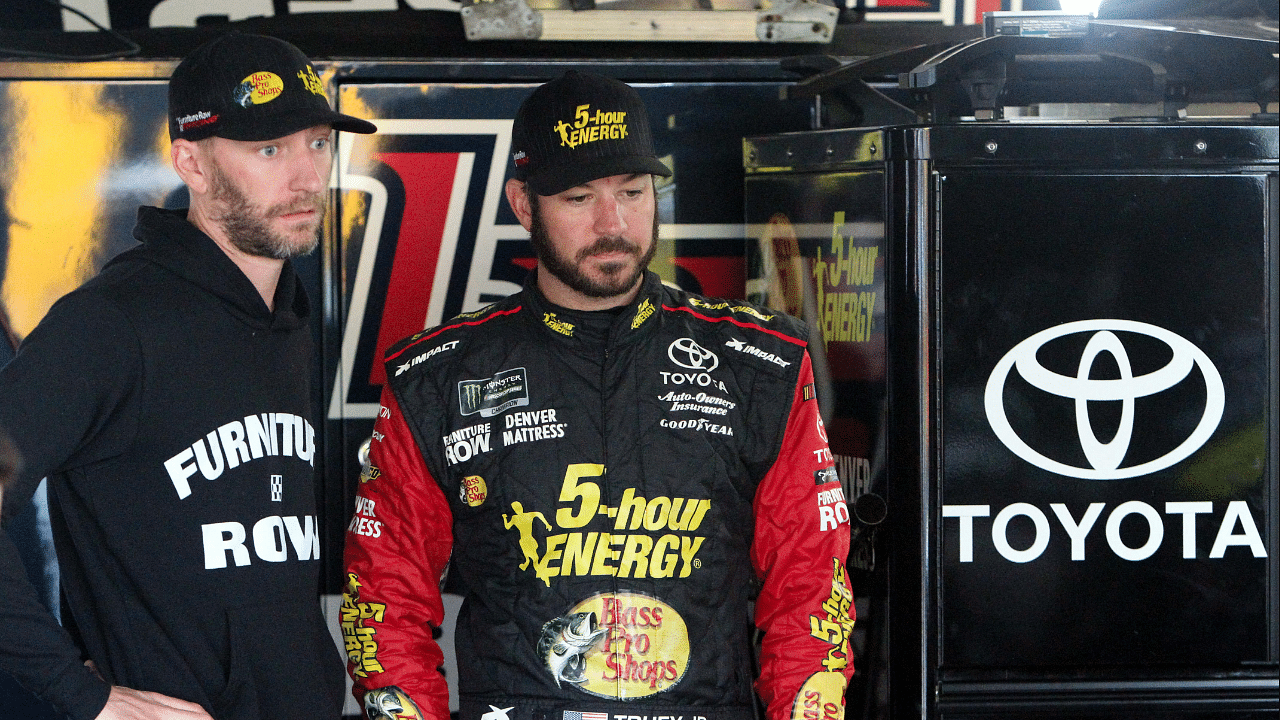 NASCAR Cup Series driver Martin Truex Jr (right) talks with his crew chief Cole Pearn (left) during practice for the Gander Outdoors 400 at Dover International Speedway.