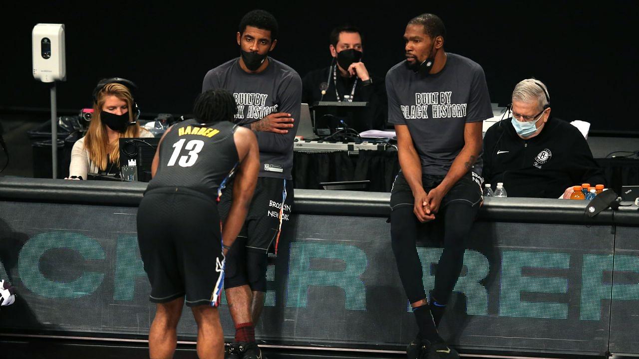 Brooklyn Nets point guard Kyrie Irving (C) and power forward Kevin Durant (R) talk to shooting guard James Harden (13) before checking into the game during the fourth quarter against the Los Angeles Clippers at Barclays Center.