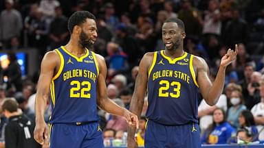 Golden State Warriors forwards Andrew Wiggins (22) and Draymond Green (23) talk during overtime against the Los Angeles Lakers at Chase Center