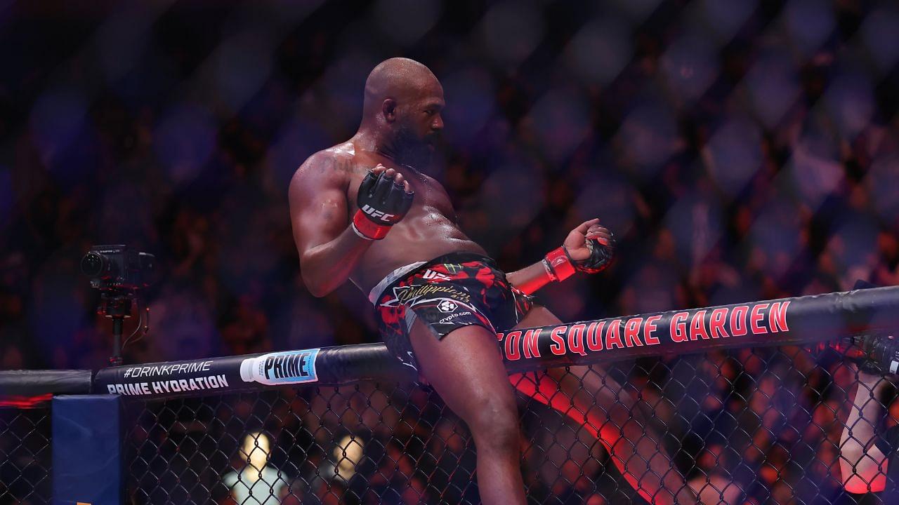 Jon Jones (red gloves) celebrates defeating Stipe Miocoic (blue gloves) in the heavyweight bout during UFC 309 at Madison Square Garden.