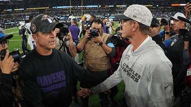 Baltimore Ravens coach John Harbaugh (left) shakes hands with brother and Los Angeles Chargers coach Jim Harbaugh after the game at SoFi Stadium.