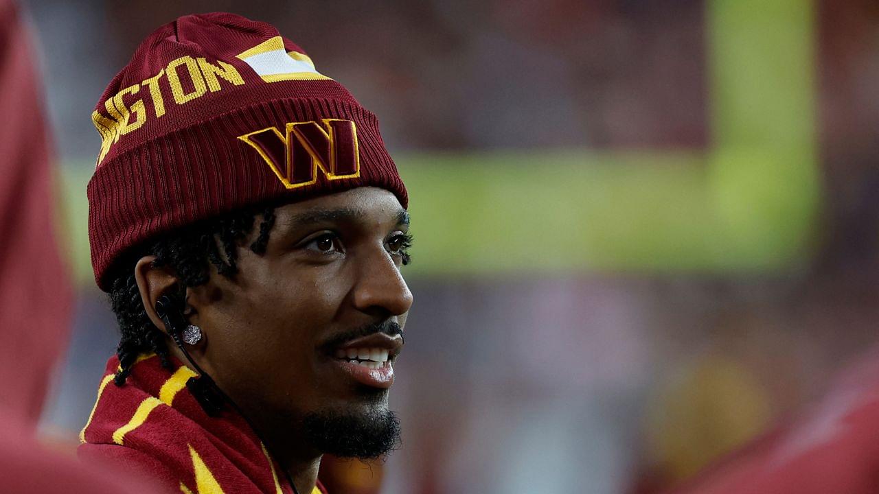 Injured Washington Commanders quarterback Jayden Daniels looks on from the sidelines against the Carolina Panthers during the third quarter at Northwest Stadium.