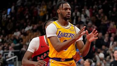 Los Angeles Lakers guard Bronny James (9) looks for a pass as Toronto Raptors guard Ja'Kobe Walter (14) defends during the second half at Scotiabank Arena.