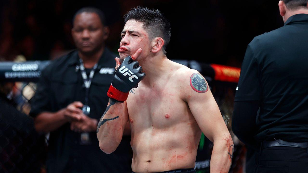 Brandon Moreno (red gloves) celebrates after defeating Amir Albazi (not pictured) in a flyweight bout during UFC Fight Night at Rogers Place.