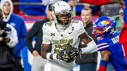 Nov 23, 2024; Kansas City, Missouri, USA; Colorado wide receiver Travis Hunter (12) catches the ball ahead of Kansas cornerback Cobee Bryant (2) for a touchdown during the 3rd quarter between the Kansas Jayhawks and the Colorado Buffaloes at GEHA Field at Arrowhead Stadium.