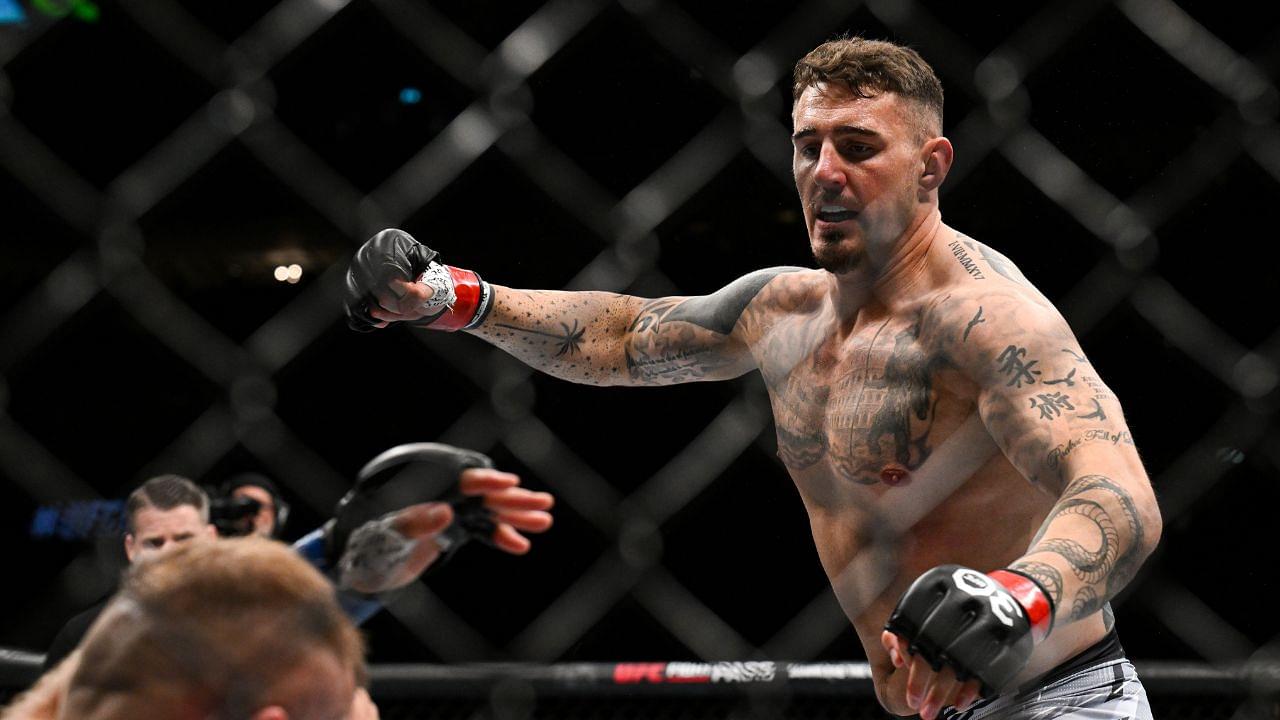 Tom Aspinall (red gloves) fights Marcin Tybura (blue gloves) during UFC Fight Night at O2 Arena.