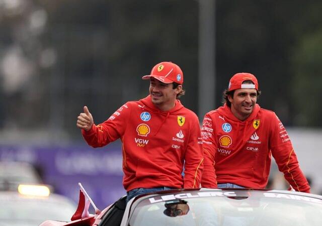 Ferrari's Spanish driver Carlos Sainz (R) and Monegasque driver Charles Leclerc react during the parade through the streets before the Formula One Mexico Grand Prix