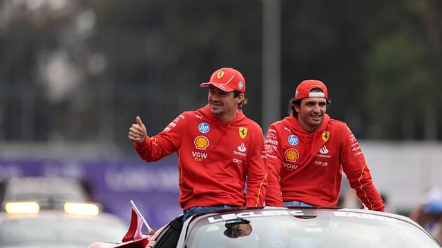 Ferrari's Spanish driver Carlos Sainz (R) and Monegasque driver Charles Leclerc react during the parade through the streets before the Formula One Mexico Grand Prix