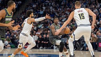 Minnesota Timberwolves guard Anthony Edwards (5) looks to pass to center Rudy Gobert (27)with Denver Nuggets guard Jamal Murray (27) and center Nikola Jokic (15) defending in the first quarter at Target Center.