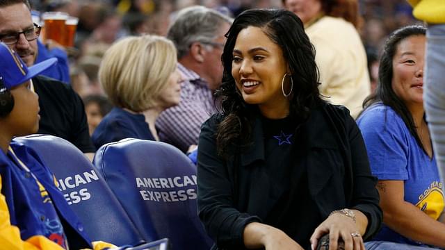 Ayesha Curry talks to a fan during a timeout between the Golden State Warriors and the Atlanta Hawks in the second quarter at Oracle Arena.