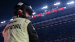 A NASCAR official watches during the Bass Pro Shops Night Race at Bristol Motor Speedway.