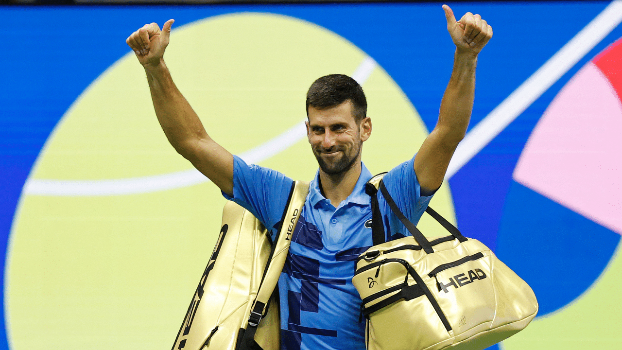 Novak Djokovic (SRB) waves to the crowd while leaving the court