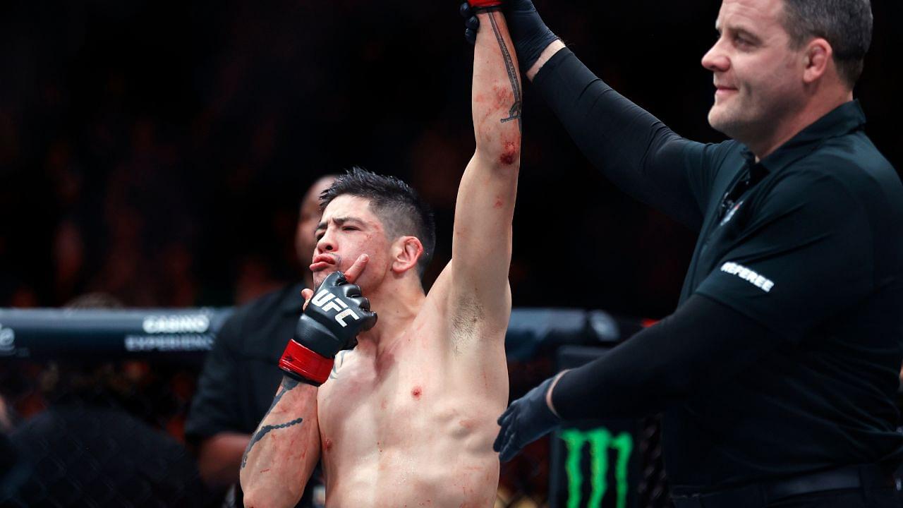 Brandon Moreno (red gloves) celebrates after defeating Amir Albazi (not pictured) in a flyweight bout during UFC Fight Night at Rogers Place.