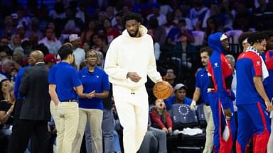 Philadelphia 76ers center Joel Embiid in plain clothes dribbles the ball during a timeout in the second quarter against the Milwaukee Bucks at Wells Fargo Center.