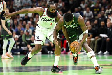 Minnesota Timberwolves guard Anthony Edwards (5) and LA Clippers guard James Harden (1) compete for the ball during the second half of an NBA Cup game at Target Center.