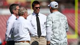 former NFL quarterback Tom Brady talks to Tampa Bay Buccaneers staff before a game against the San Francisco 49ers at Raymond James Stadium.