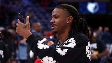 Memphis Grizzlies guard Ja Morant (12) takes videos with his phone, after the game against the Denver Nuggets at FedExForum.