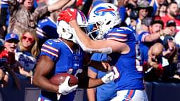 Oct 20, 2024; Orchard Park, New York, USA; Buffalo Bills tight end Dalton Kincaid (86) congratulates Buffalo Bills wide receiver Amari Cooper (18) for scoring a touchdown against the Tennessee Titans during the second half at Highmark Stadium.