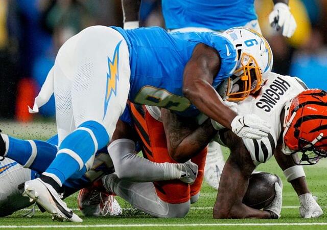 Los Angeles Chargers linebacker Denzel Perryman (6) drives into Cincinnati Bengals wide receiver Tee Higgins (5) as he is brought down in the first quarter of the NFL Week 11 game between the Los Angeles Chargers and the Cincinnati Bengals at SoFi Stadium.