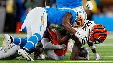 Los Angeles Chargers linebacker Denzel Perryman (6) drives into Cincinnati Bengals wide receiver Tee Higgins (5) as he is brought down in the first quarter of the NFL Week 11 game between the Los Angeles Chargers and the Cincinnati Bengals at SoFi Stadium.