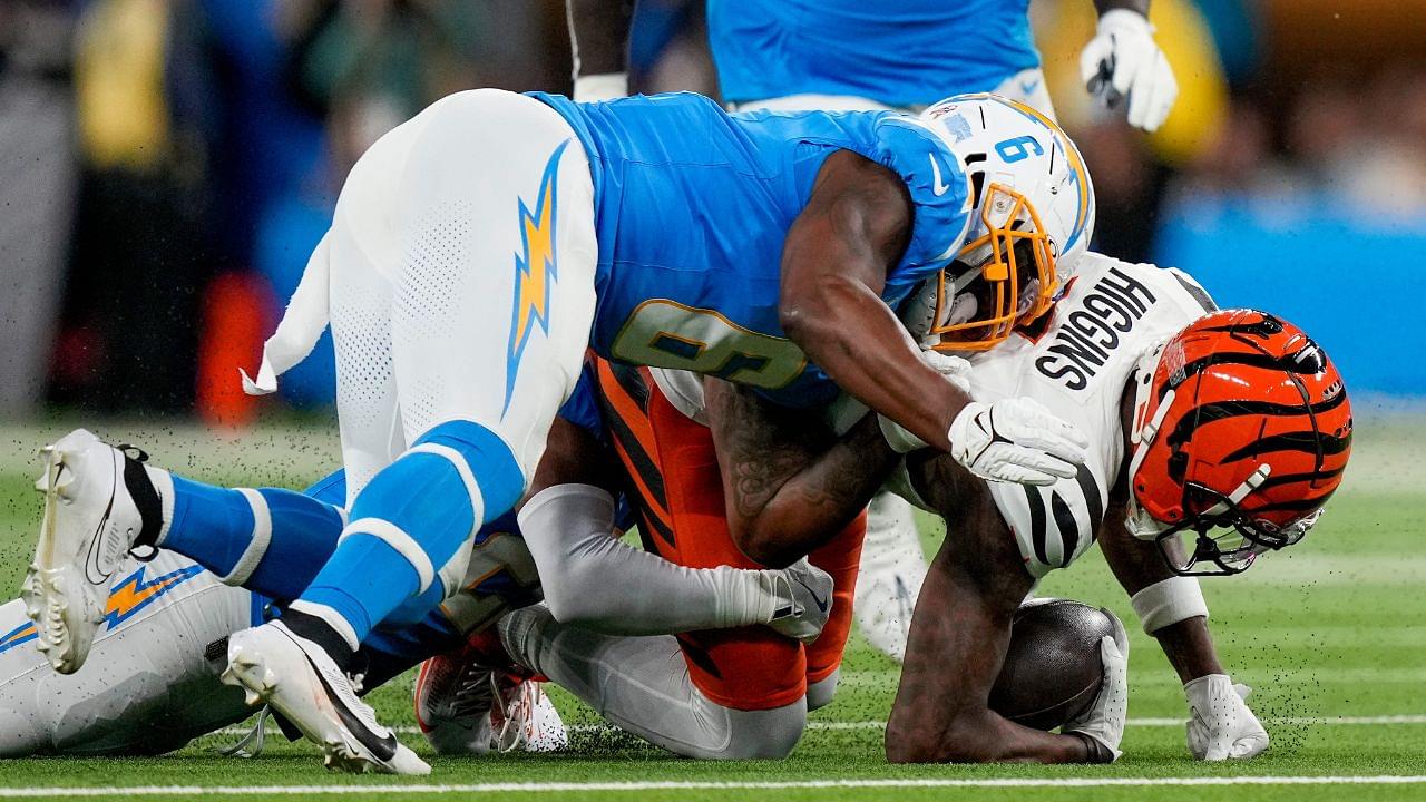 Los Angeles Chargers linebacker Denzel Perryman (6) drives into Cincinnati Bengals wide receiver Tee Higgins (5) as he is brought down in the first quarter of the NFL Week 11 game between the Los Angeles Chargers and the Cincinnati Bengals at SoFi Stadium.