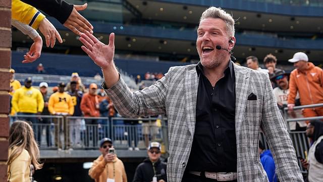 ESPN College Game Day's Pat McAfee high-fives fans as he takes the field before the game between Michigan and Texas at Michigan Stadium in Ann Arbor on Saturday, September 7, 2024.