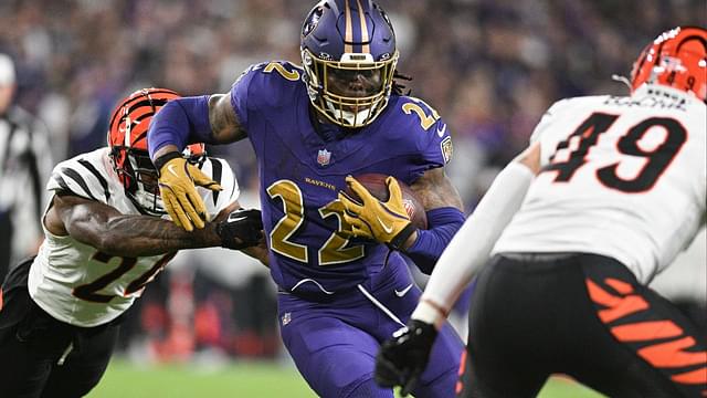 Baltimore Ravens running back Derrick Henry (22) rushes as Cincinnati Bengals safety Jordan Battle (27) and linebacker Joe Bachie (49) defends during the second half at M&T Bank Stadium.