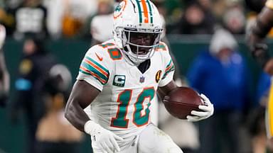 Nov 28, 2024; Green Bay, Wisconsin, USA; Miami Dolphins wide receiver Tyreek Hill (10) rushes with the football during the fourth quarter against the Green Bay Packers at Lambeau Field.