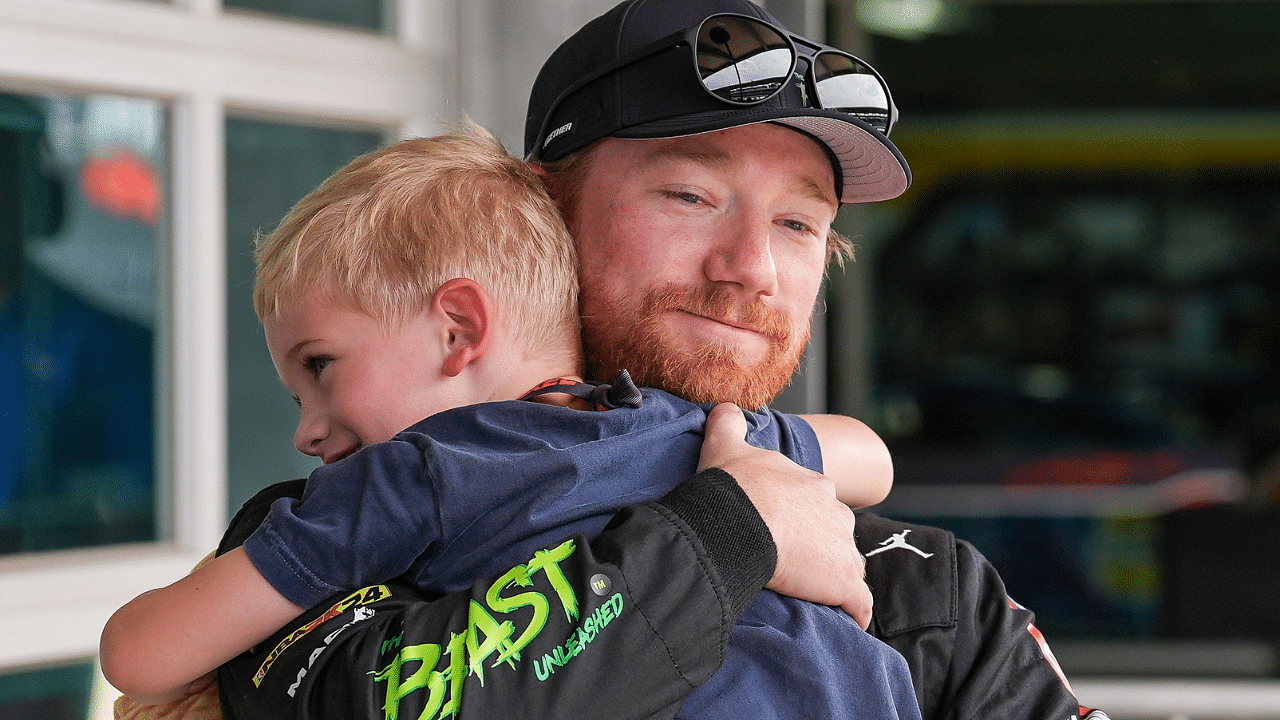 NASCAR Cup Series driver Tyler Reddick (45) hugs his son Beau, 4, after qualifying on pole position for the Brickyard 400, Saturday, July 20, 2024, at Indianapolis Motor Speedway.