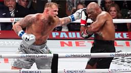 Mike Tyson (black gloves) fights Jake Paul (silver gloves) at AT&T Stadium.