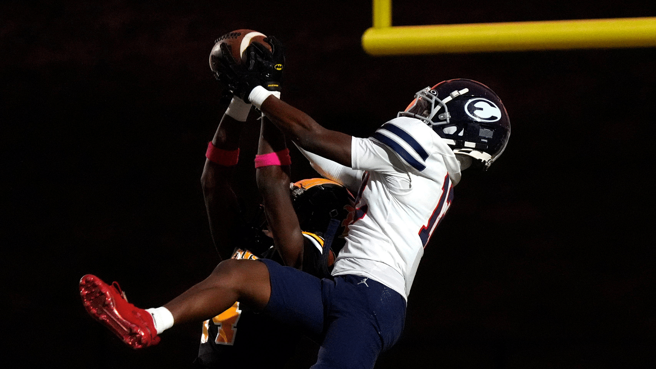 Evans cornerback Christian Scott (14) and Effingham wide receiver Trayvis Hunter (12) jump for the ball during the Evans and Effingham County football game at Evans High School on Wednesday, Oct. 9, 2024. This week marks the return of high school football after Hurricane Helene. Effingham County defeated Evans with a score of 35-7.