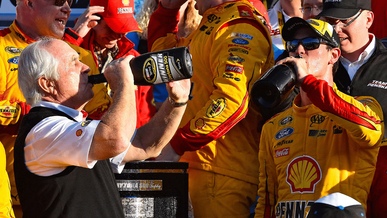 NASCAR Sprint Cup Series driver Joey Logano (22) celebrates with team owner Roger Penske in victory lane after winning the Daytona 500 at Daytona International Speedway.