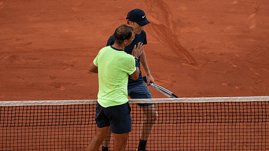 Rafael Nadal (ESP) at the net with Jannik Sinner (ITA)