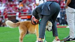 ESPN commentator Kirk Herbstreit hugs his dog Ben before the game between the Oklahoma Sooners and Tennessee Volunteers at Gaylord Family-Oklahoma Memorial Stadium.