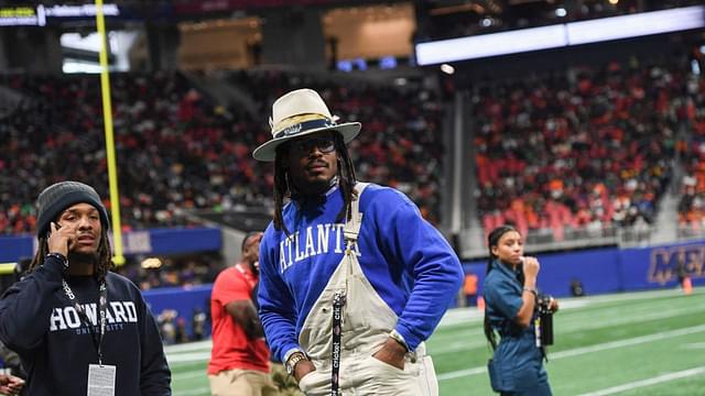 Former Auburn and NFL star Cam Newton stands on the sidelines during the Cricket Celebration Bowl game between Florida A&M University and Howard University at Mercedes-Benz Stadium in Atlanta on Dec. 16, 2023.