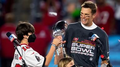 ampa Bay Buccaneers quarterback Tom Brady (12) and son John Jack Brady celebrate with the Vince Lombardi Trophy after beating the Kansas City Chiefs in Super Bowl LV at Raymond James Stadium.