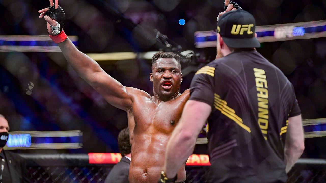 Francis Ngannou (red gloves) celebrates after the fight against Ciryl Gane (blue gloves) during UFC 270 at Honda Center.