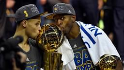 Golden State Warriors guard Stephen Curry (30) poses with the Larry O'Brien Trophy as Golden State Warriors guard Andre Iguodala (9) celebrates with the NBA Finals MVP trophy after beating the Cleveland Cavaliers in game six of the NBA Finals at Quicken Loans Arena