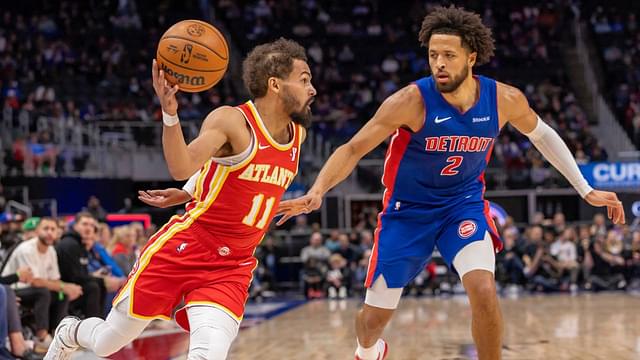 Atlanta Hawks guard Trae Young (11) moves the ball up court next to Detroit Pistons guard Cade Cunningham (2) during the first half at Little Caesars Arena.