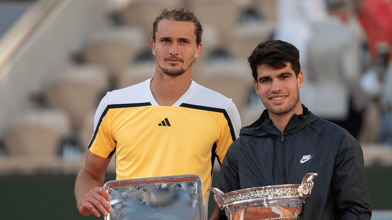 Carlos Alcaraz of Spain and Alexander Zverev of Germany pose with their trophies at the trophy presentation on day 15 of Roland Garros at Stade Roland Garros.