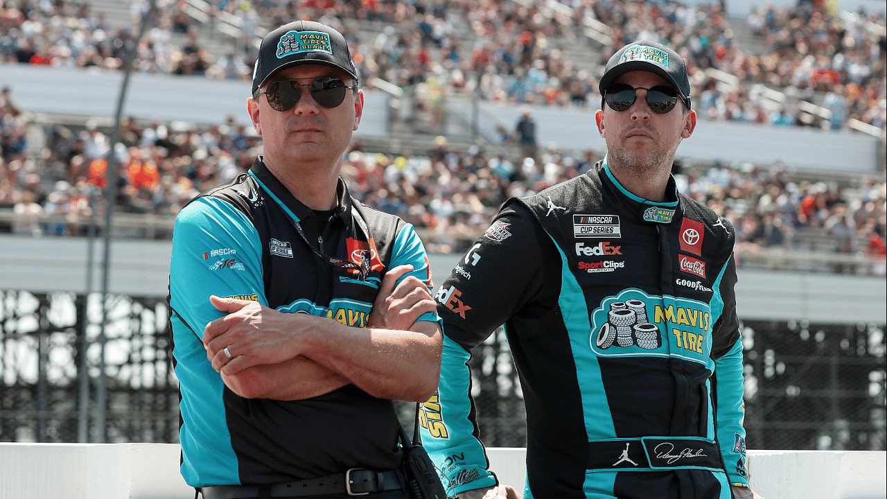 NASCAR Cup Series driver Denny Hamlin (right) stands with his crew chief Chris Gabehart (left) on pit road prior to The Great American Getaway 400 at Pocono Raceway.