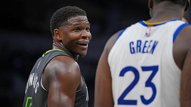 Minnesota Timberwolves guard Anthony Edwards (5) talks to Golden State Warriors forward Draymond Green (23) during a free throw in the third quarter at Target Center.