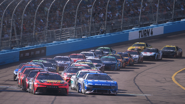 Cars race in a pack as the caution flag comes out during the Shriners Children's 500 at Phoenix Raceway.