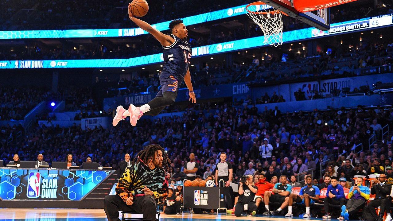 New York Knicks forward Dennis Smith Jr dunks over Recording artist J Cole in the Slam Dunk Contest during the NBA All-Star Saturday Night at Spectrum Center.