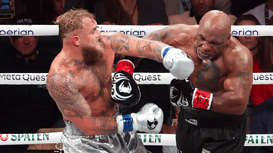 Mike Tyson (black gloves) fights Jake Paul (silver gloves) at AT&T Stadium.