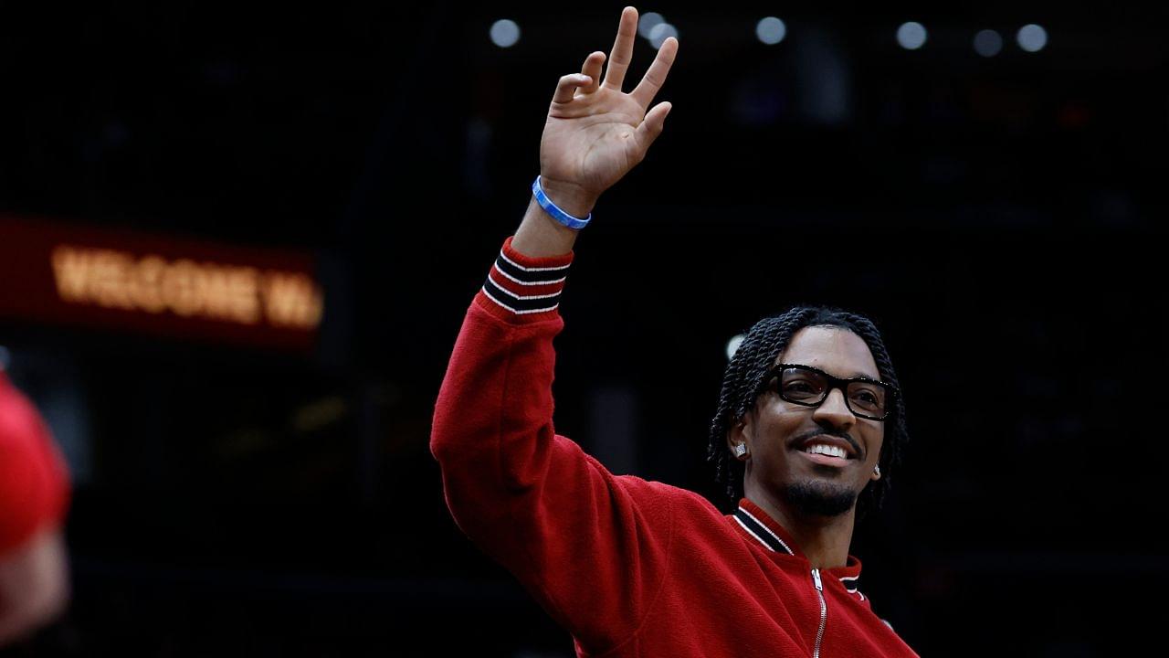 Washington Commanders quarter back Jayden Daniels waves to the crowd from courtside during a timeout in the game between the Washington Wizards and Golden State Warriors in the first half at Capital One Arena.