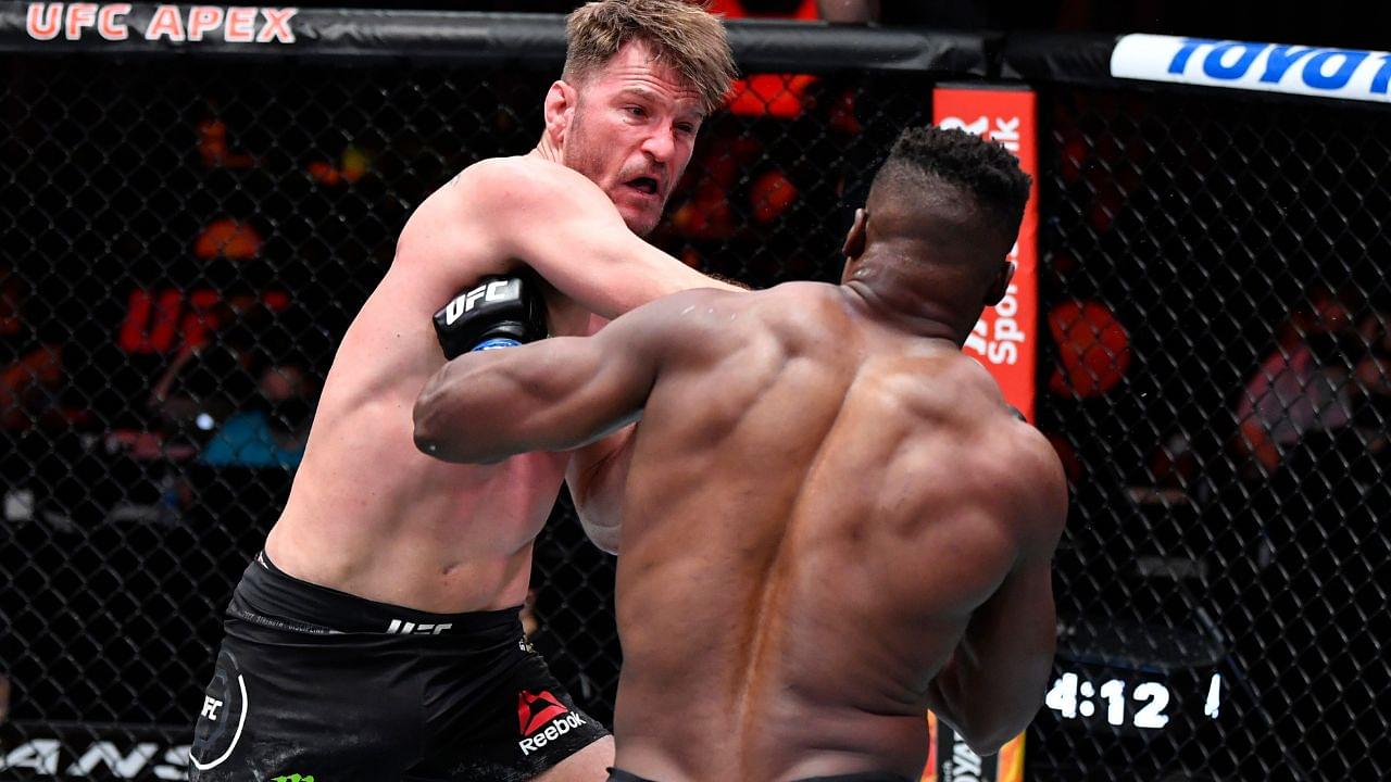 Stipe Miocic punches Francis Ngannou of Cameroon in their UFC heavyweight championship fight during the UFC 260 event at UFC APEX on March 27, 2021 in Las Vegas, Nevada.