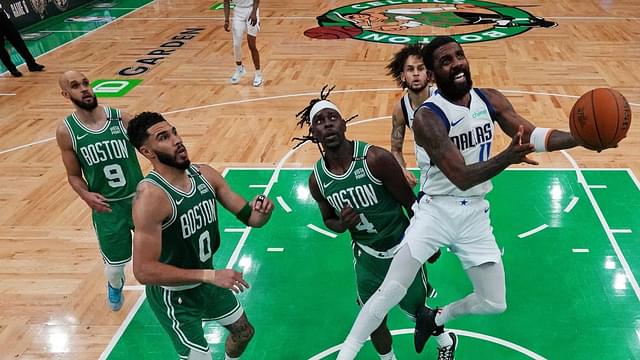 Dallas Mavericks guard Kyrie Irving (11) shoots the ball against Boston Celtics guard Jrue Holiday (4) in game five of the 2024 NBA Finals at TD Garden.