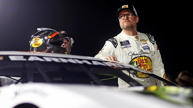 Dale Earnhardt Jr. waits next to his during qualifying for the 16th Annual Hampton Heat at Langley Speedway.