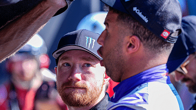 NASCAR Cup Series driver Tyler Reddick (45) listens to teammate Bubba Wallace (23) during cup qualifying at Martinsville Speedway.